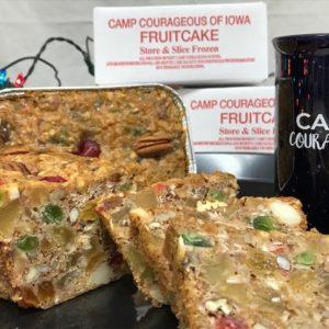Slices of fruitcake with the box and a mug.