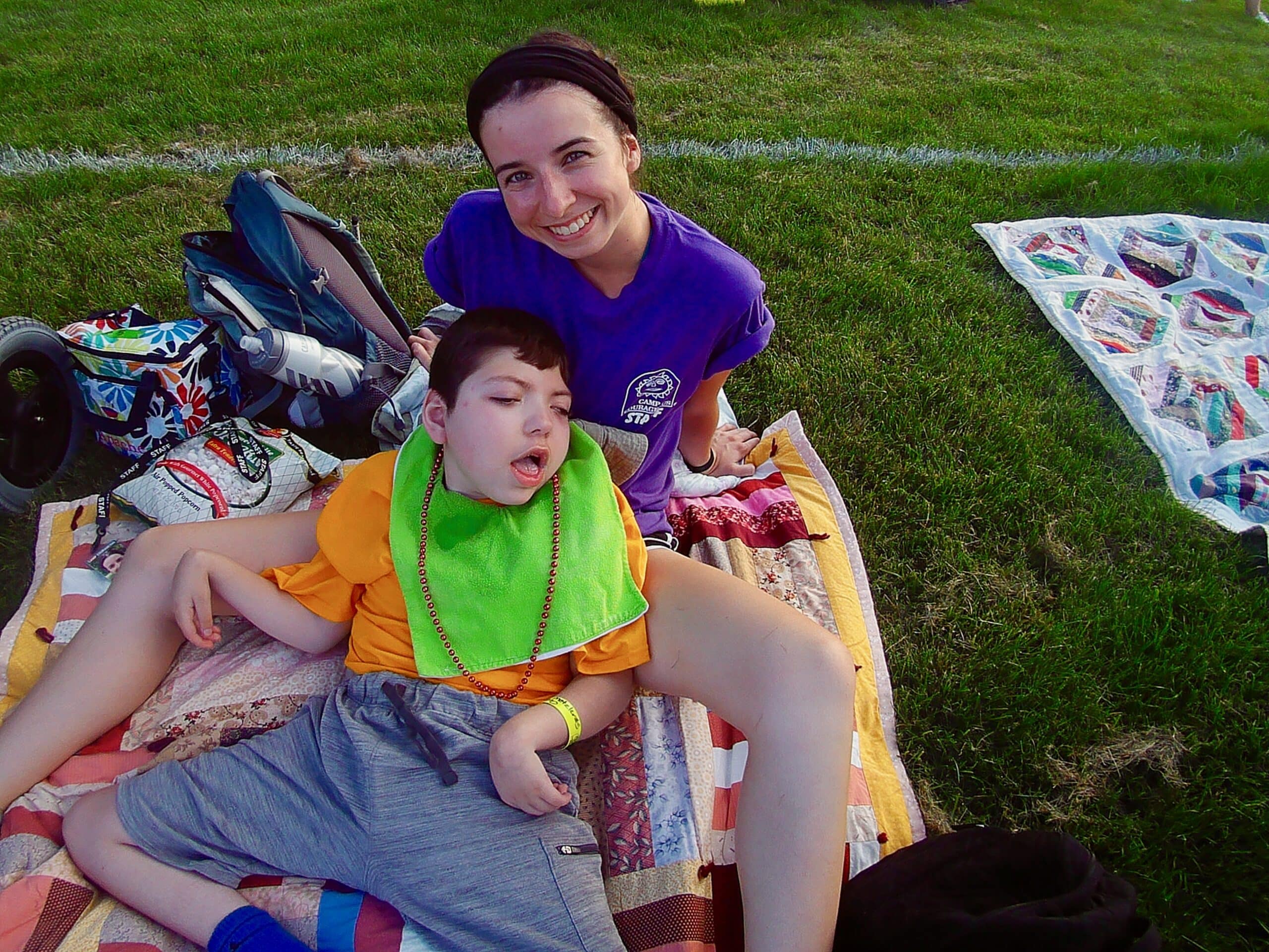 Camper Tristan with Counselor Tracy, waiting for the sun to set prior to the 4th of July fireworks