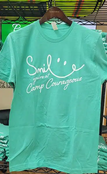 mint green t-shirt with a smile graphic