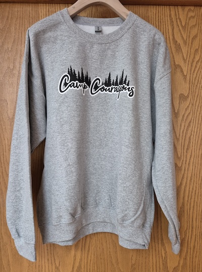 Grey crew neck sweatshirt with tree line back ground